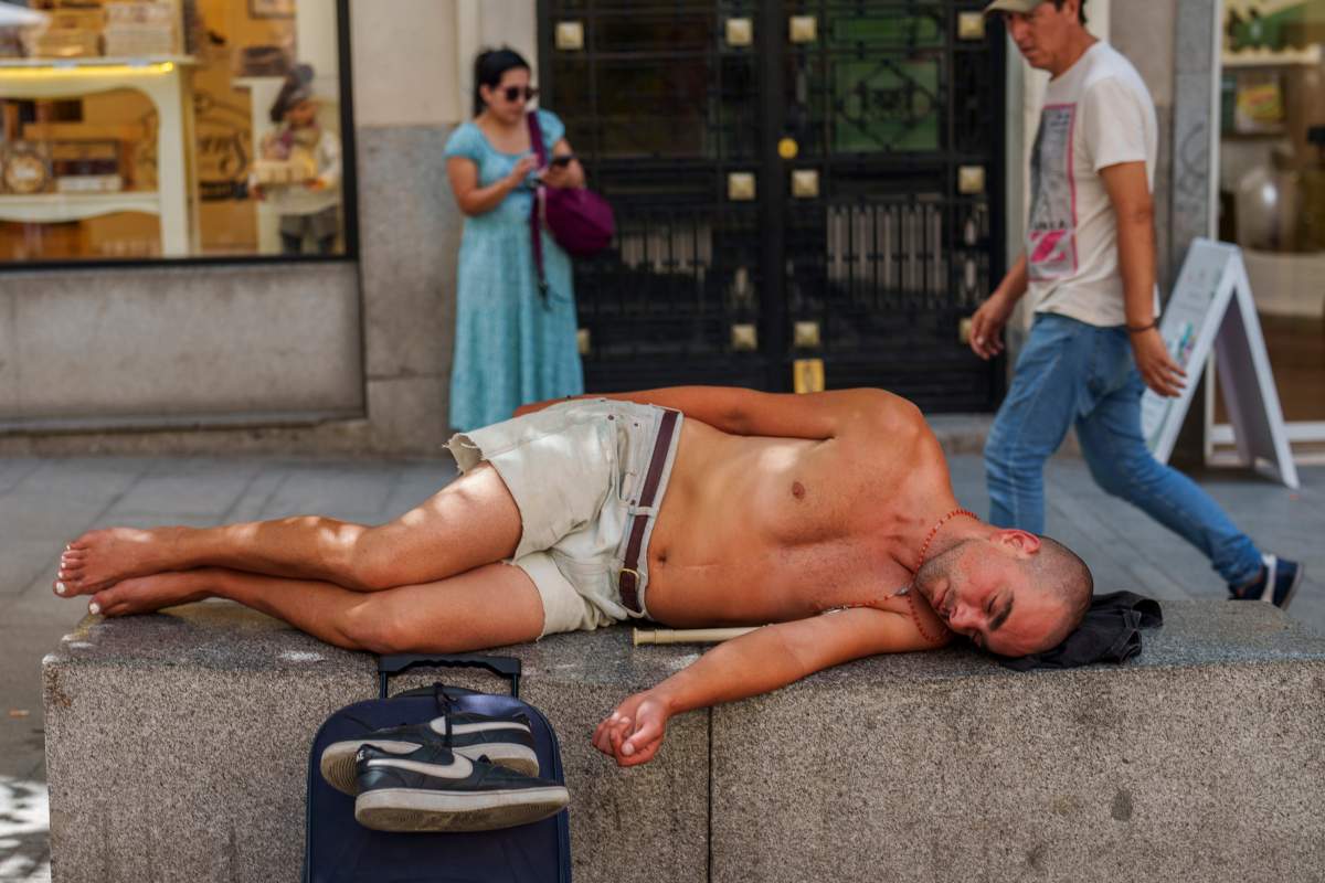 A man rests during a hot and sunny day of summer in Madrid, Spain, Wednesday, July 19, 2023. Most of Spain is under alert for high to extreme heat with forecasts calling for peak temperatures of 43 C (109 F). (AP Photo/Manu Fernandez)