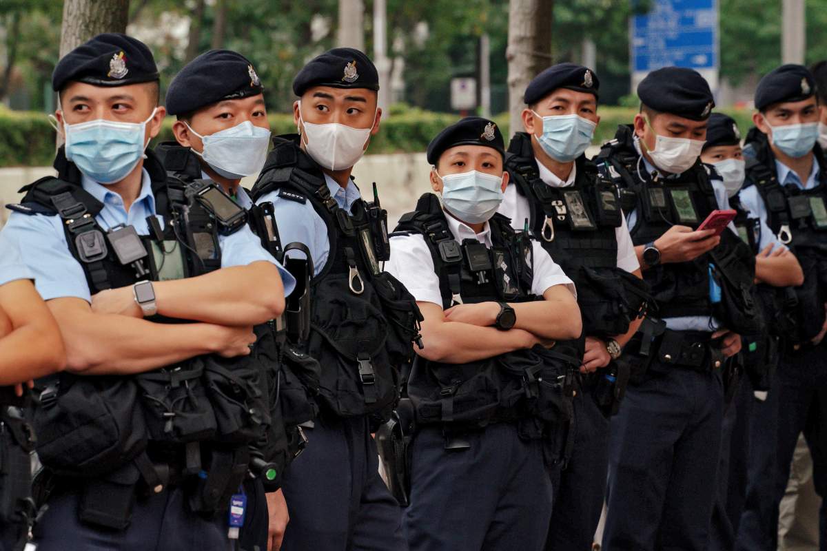 Policemen wearing face masks stand guard outside the West Kowloon Magistrates’ Courts ahead of the national security trail for the pro-democracy activists in Hong Kong, Monday Feb. 6, 2023. Some of Hong Kong’s best-known pro-democracy activists went on trial Monday in the biggest prosecution yet under a law imposed by China’s ruling Communist Party to crush dissent. (AP Photo/ Anthony Kwan)