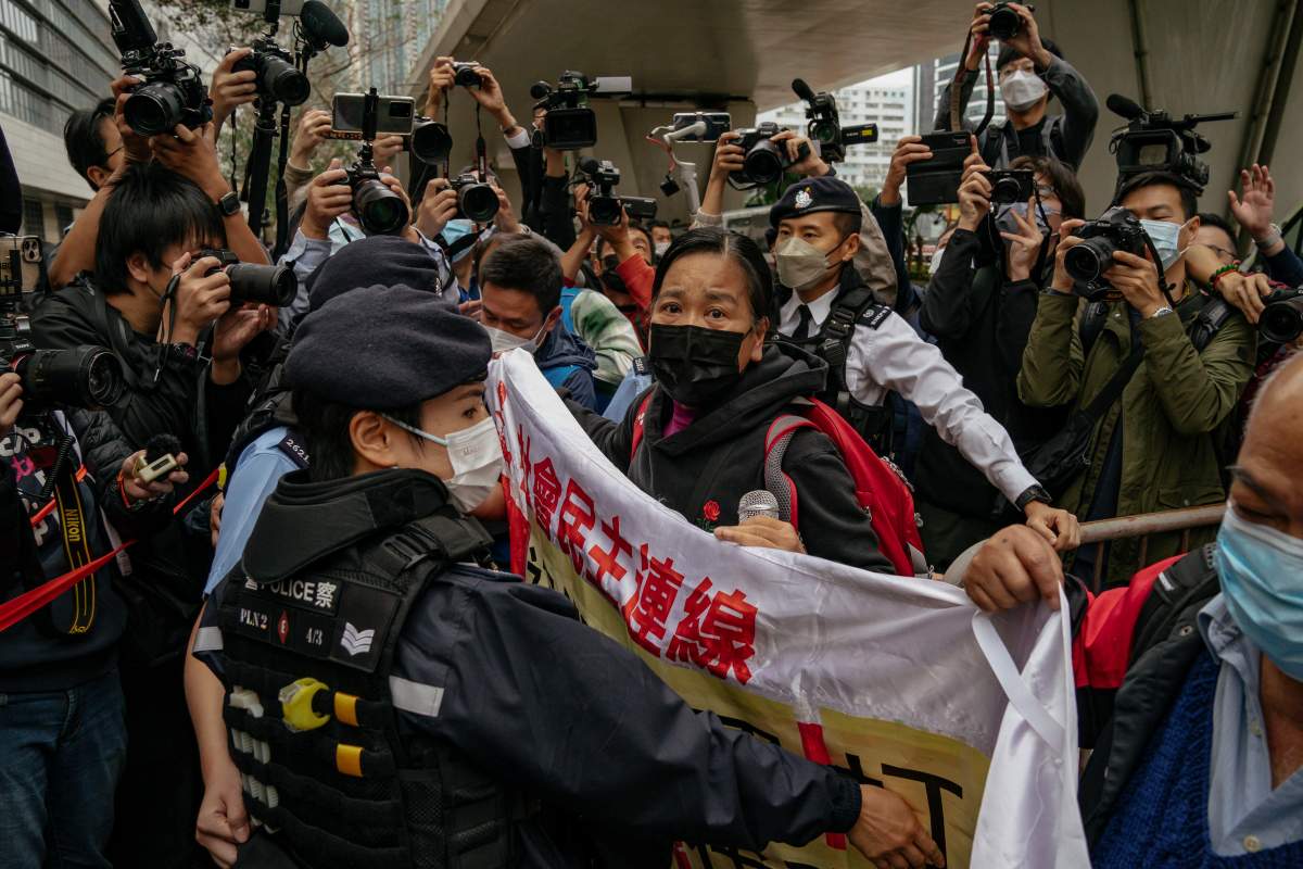 Photographers take picture of the members of League of Social Democrats scuffling with police outside the West Kowloon Magistrates’ Courts ahead of the national security trail for the pro-democracy activists in Hong Kong, Monday Feb. 6, 2023. Some of Hong Kong’s best-known pro-democracy activists went on trial Monday in the biggest prosecution yet under a law imposed by China’s ruling Communist Party to crush dissent. (AP Photo/Anthony Kwan)