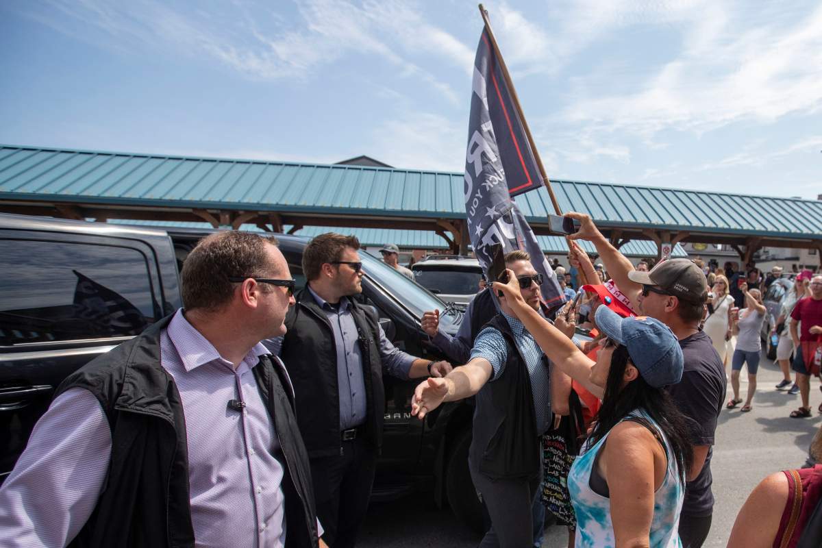 Protesters shout at Prime Minister Justin Trudeau when leaving Belleville, Ontario, on Thursday July 20, 2023. THE CANADIAN PRESS/Lars Hagberg
