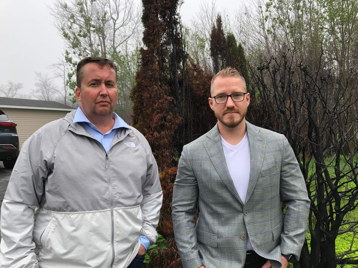 Hammonds Plains homeowner John Engram (left) stands with Francis Martin of ClearClaim Adjusters.
