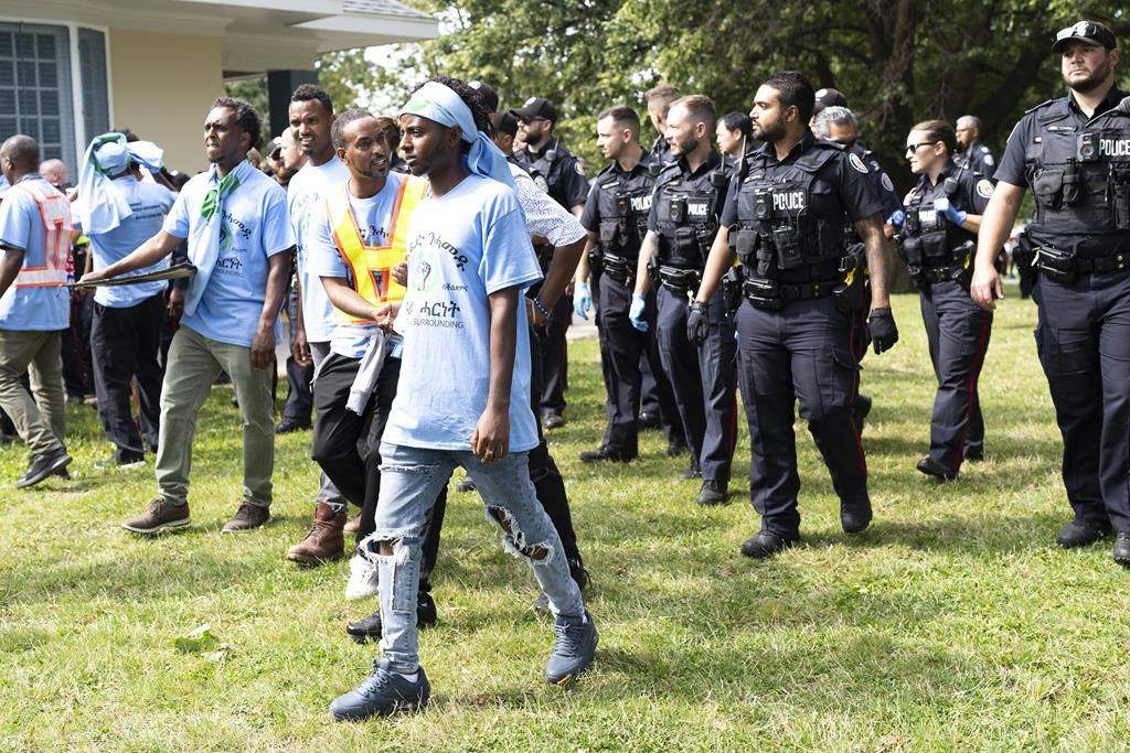 Toronto Police work the scene of a protest that turned violent in Earlscourt Park in Toronto, on Saturday, August 5 2023. Toronto police say one person was stabbed and eight others were injured during a protest in the city’s west end. THE CANADIAN PRESS/Arlyn McAdorey