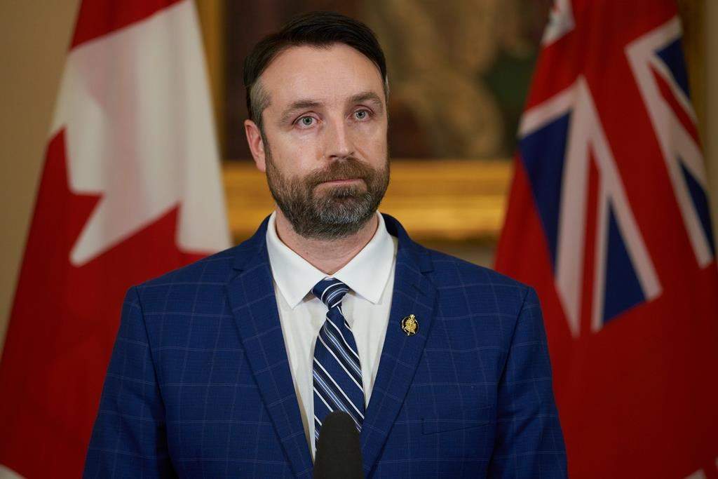 Andrew Smith speaks to the media at a press conference after he wad sworn in at the Manitoba Legislative Building in Winnipeg on Tuesday Jan. 18, 2022. He says people who are upset they can't buy alcohol due to a strike by staff at Crown-owned liquor stores should blame "the NDP and their union friends." THE CANADIAN PRESS/David Lipnowski.