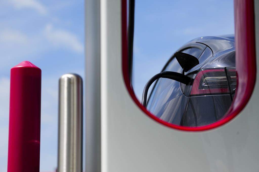 An electric vehicle is charged in Ottawa on Wednesday, July 13, 2022. 