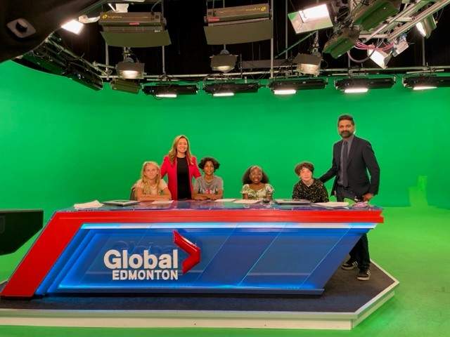 Our 2023 reporters for the day — Aaryan, Olivia, Cecily and Hudson —at the Global Edmonton anchor desk with Vinesh Pratap and Su-Ling Goh on Wednesday, August 23, 2023.
