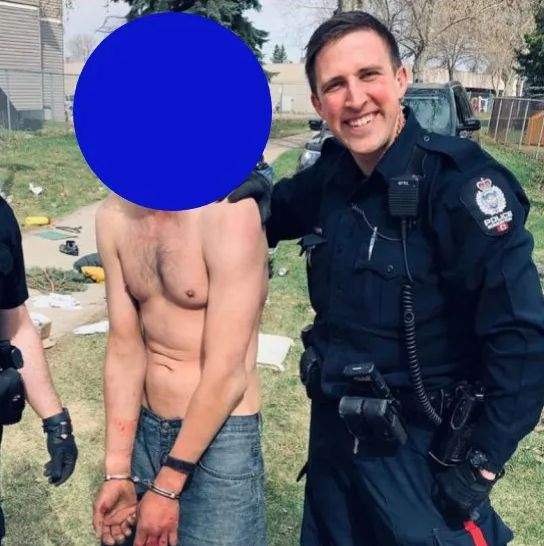 A photo posted to Instagram showing two smiling police officers, one of which was Alex Doduk, holding a man being detained in 2020. Global News has slightly altered the Instagram post in an attempt to better conceal the man's identity.
