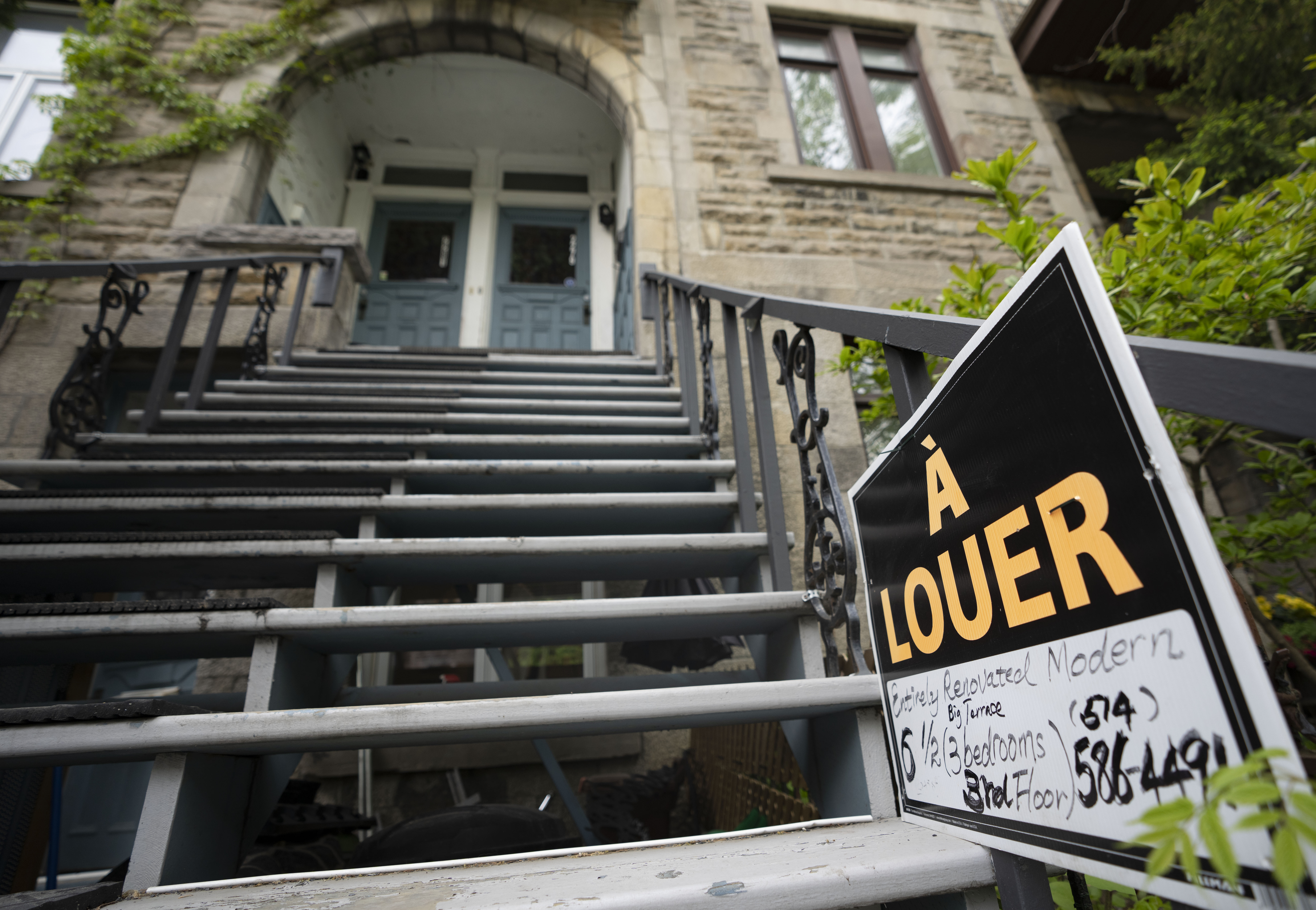 Real estate signage showing an apartment for rent is seen on Monday, May 15, 2023 in Montreal.