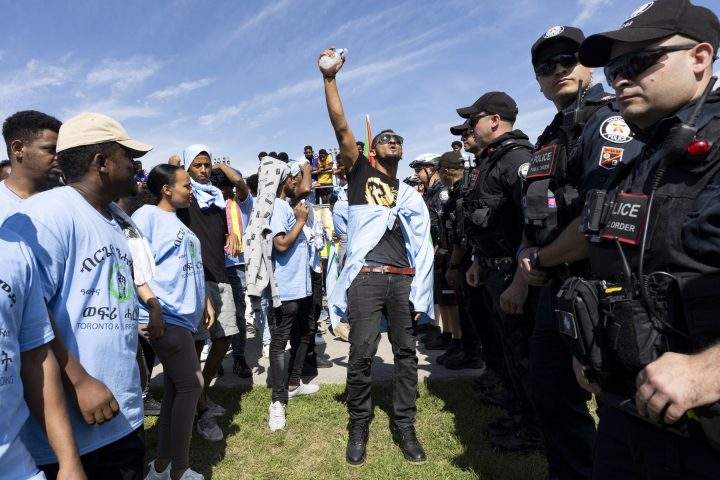 Toronto Police work the scene of a protest that turned violent in Earlscourt Park in Toronto, on Saturday, Aug. 5, 2023. Toronto police say one person was stabbed and eight others were injured during a protest in the city’s west end.