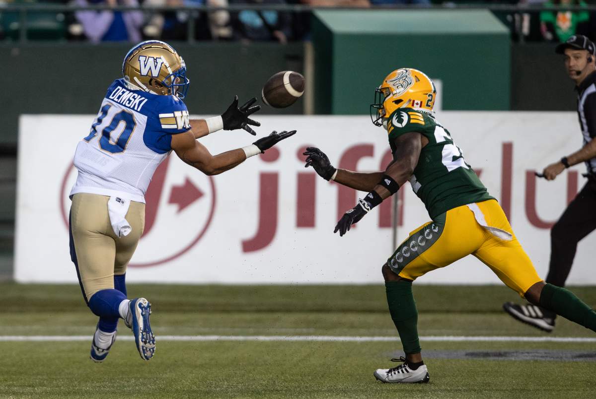 Winnipeg Blue Bombers' Nic Demski (10) makes the catch as Edmonton Elks' Darrius Bratton (24) tries to stop him during second half CFL action in Edmonton, Alta., on Thursday August 10, 2023.