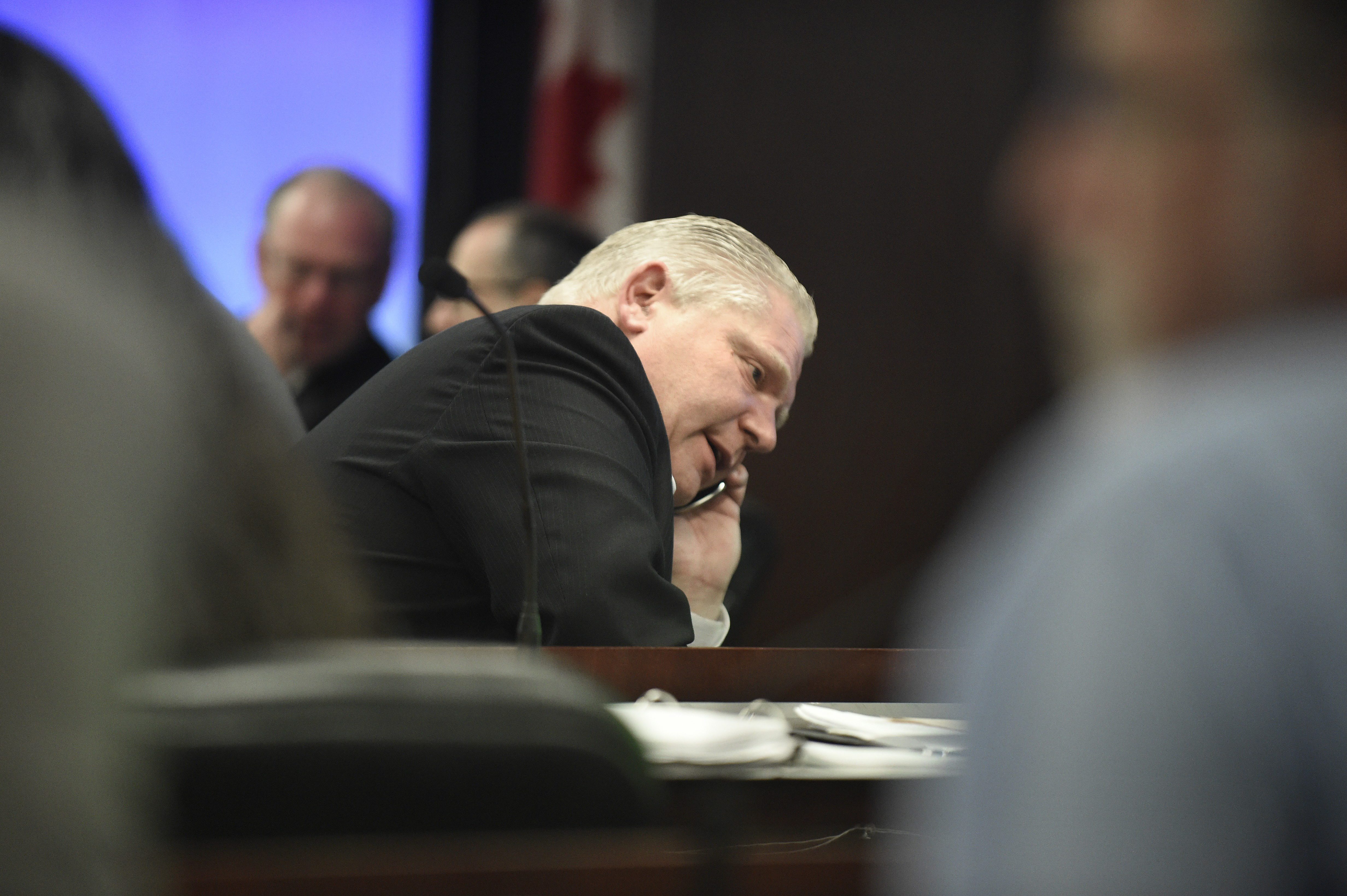 Toronto councillor Doug Ford speaks on his mobile phone while attending a government management meeting at city hall on May 12 2014.