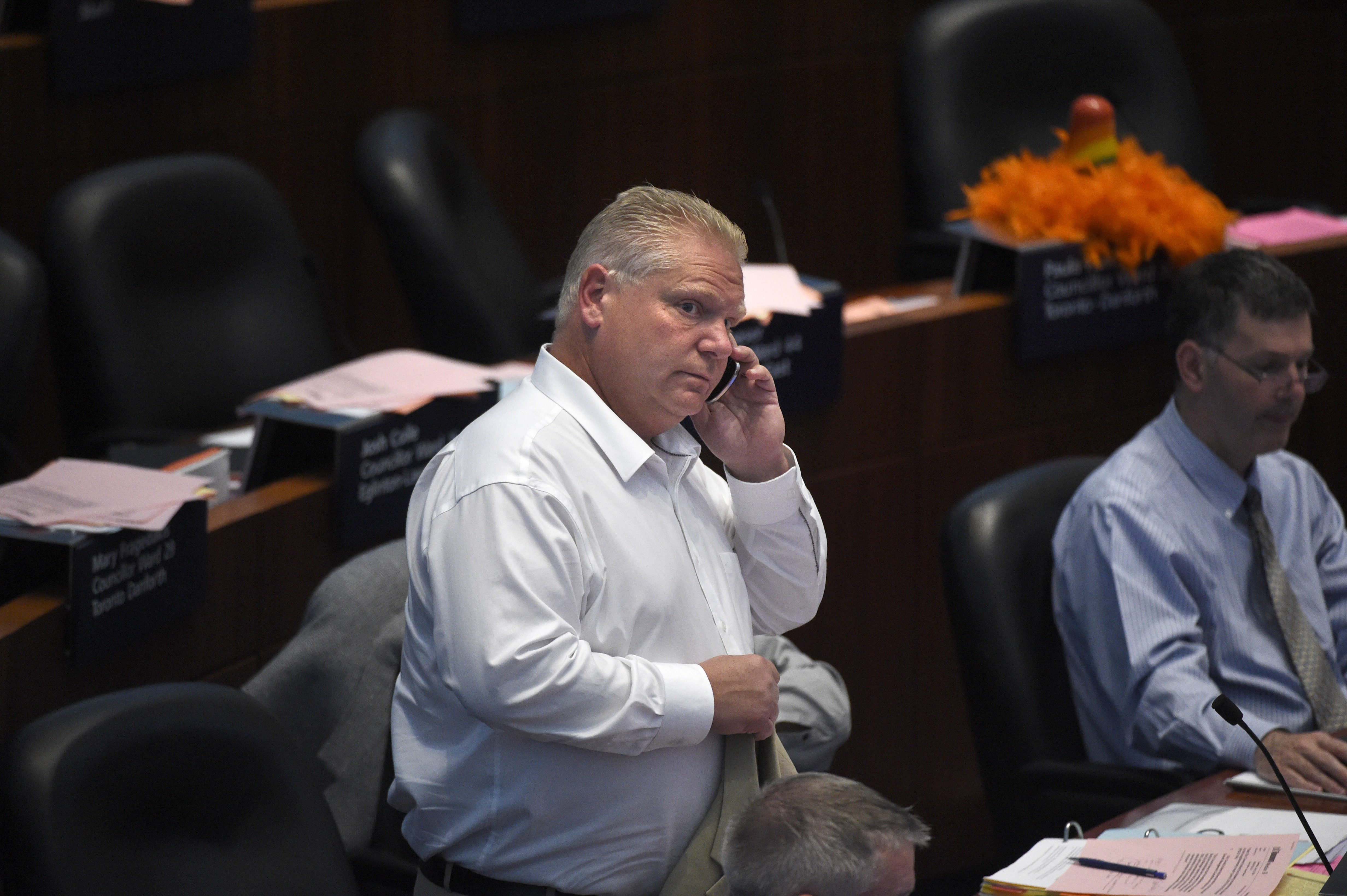 Toronto city councillor Doug Ford is photographed taking a phone call during council meeting at Toronto city hall on July 10 2014.