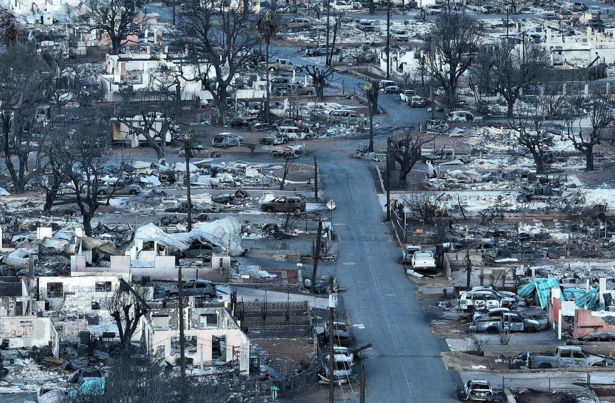 Houses and cars have been reduced to rubble.