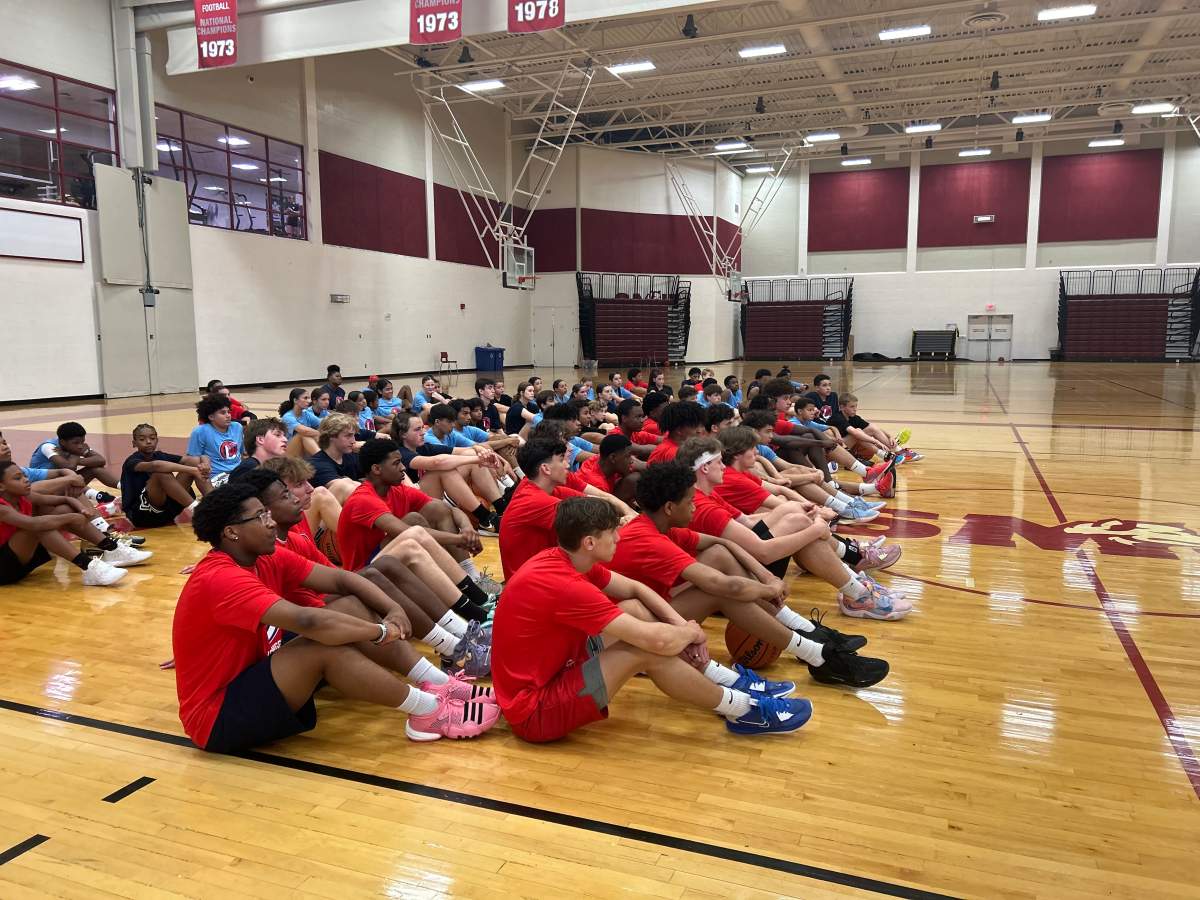 Attendees listen to some opening remarks before kicking off a weekend of basketball.