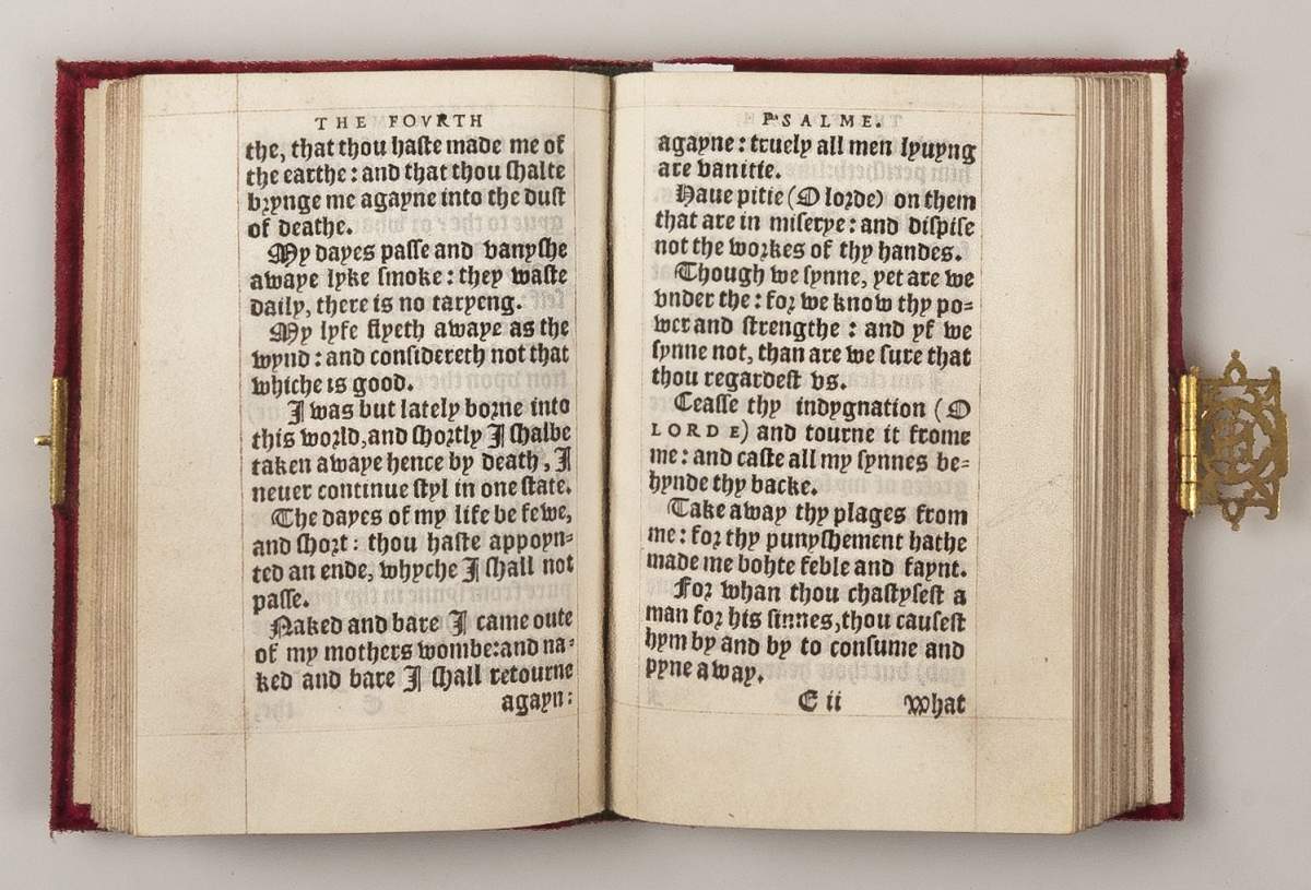 A religious book of stylized text with a faint hand-drawn doodle in the far right margin.