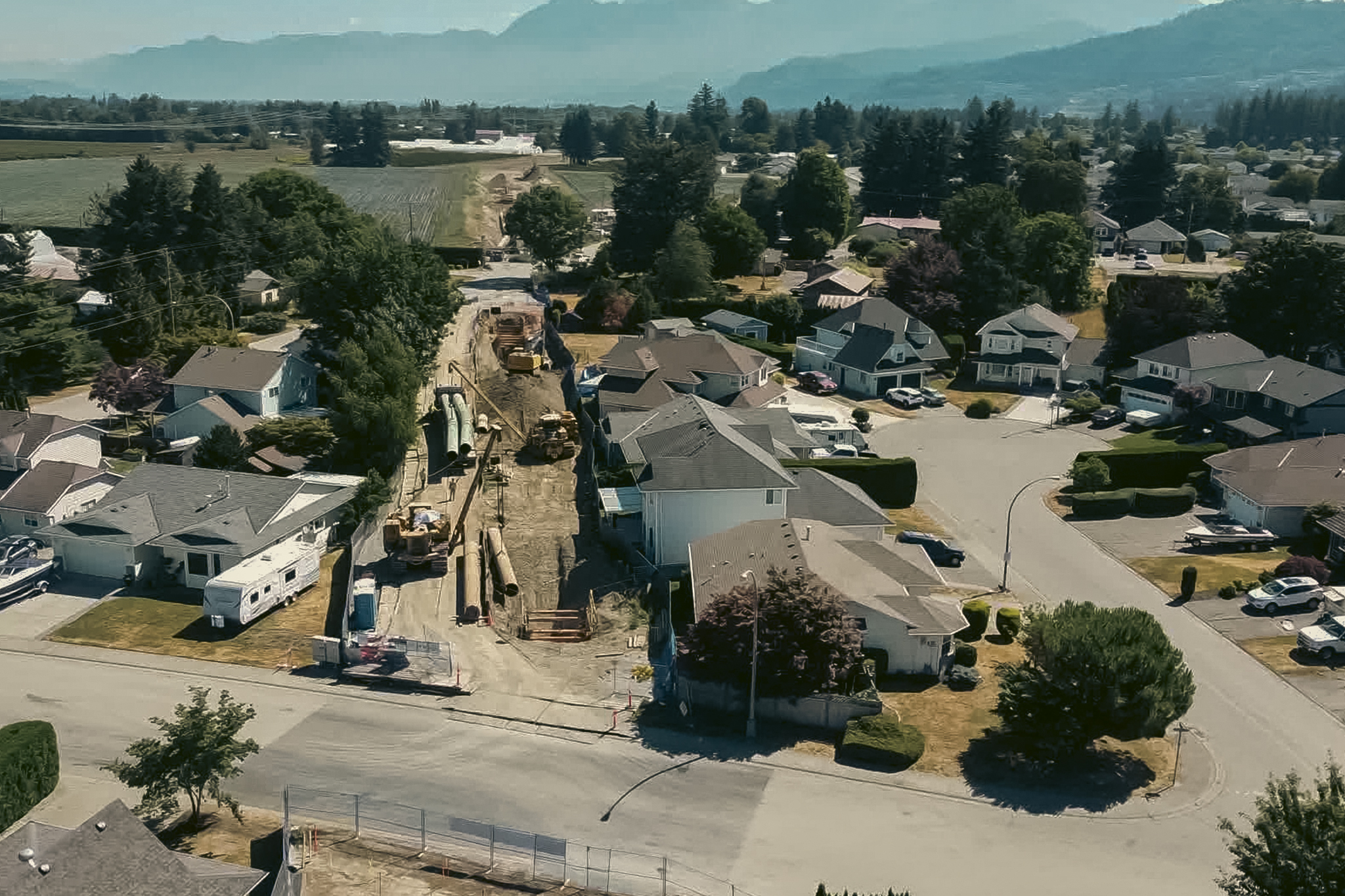 A screenshot from drone footage showing the Trans Mountain expansion project under construction in a neighbourhood in Chilliwack, B.C. The controversial line will triple the amount of oil shipped from Alberta to the West Coast.