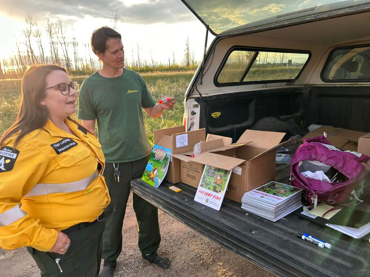 Alberta Wildfire officials greeting Northwest Territories evacuees, providing fuel and bottled waters as they enter the province near Steen River on Thursday, August 17, 2023.