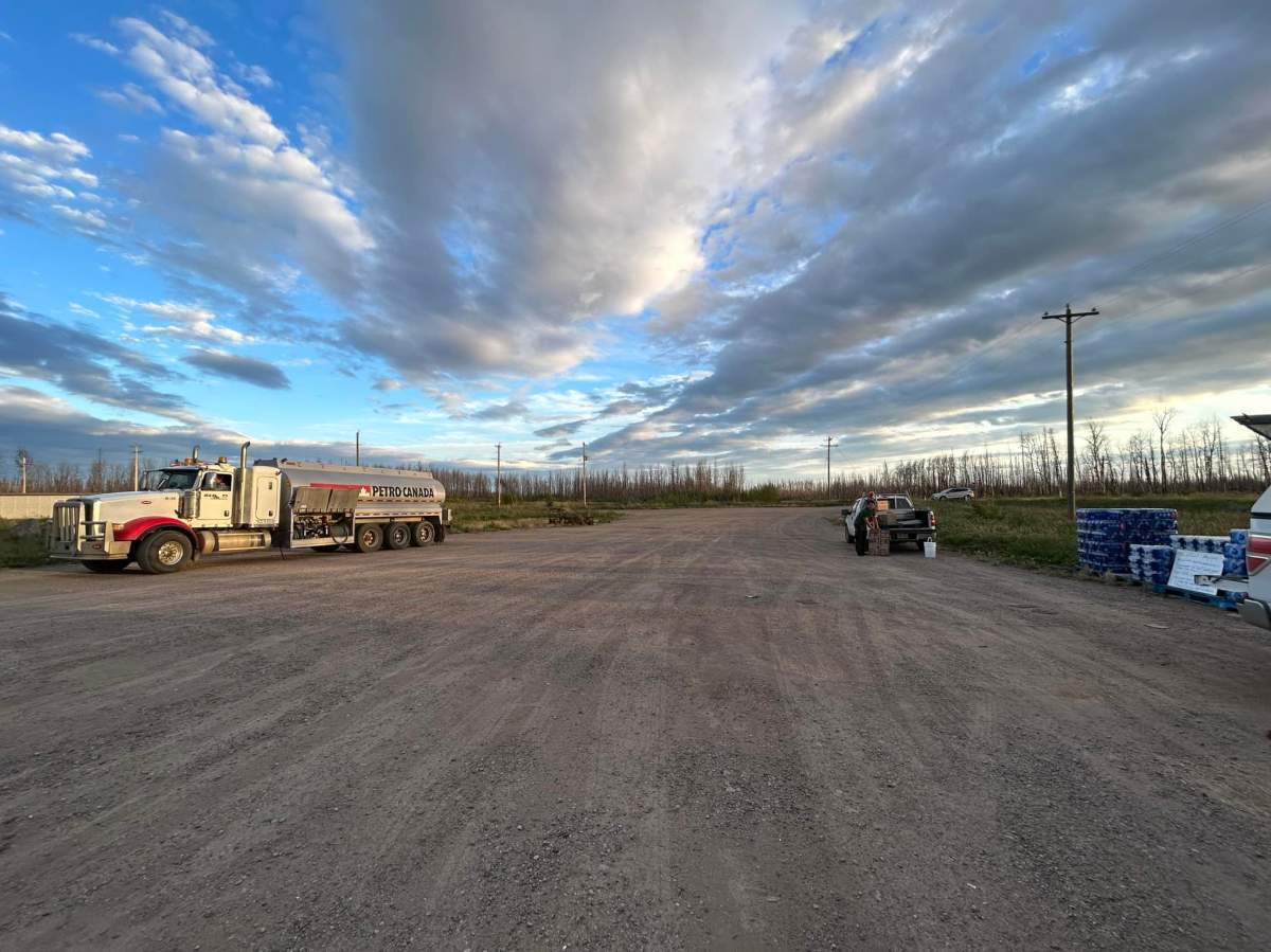 Alberta Wildfire officials and a fuel truck from Petro Canada greeting Northwest Territories evacuees, providing fuel and bottled waters as they enter the province near Steen River on Thursday, August 17, 2023.