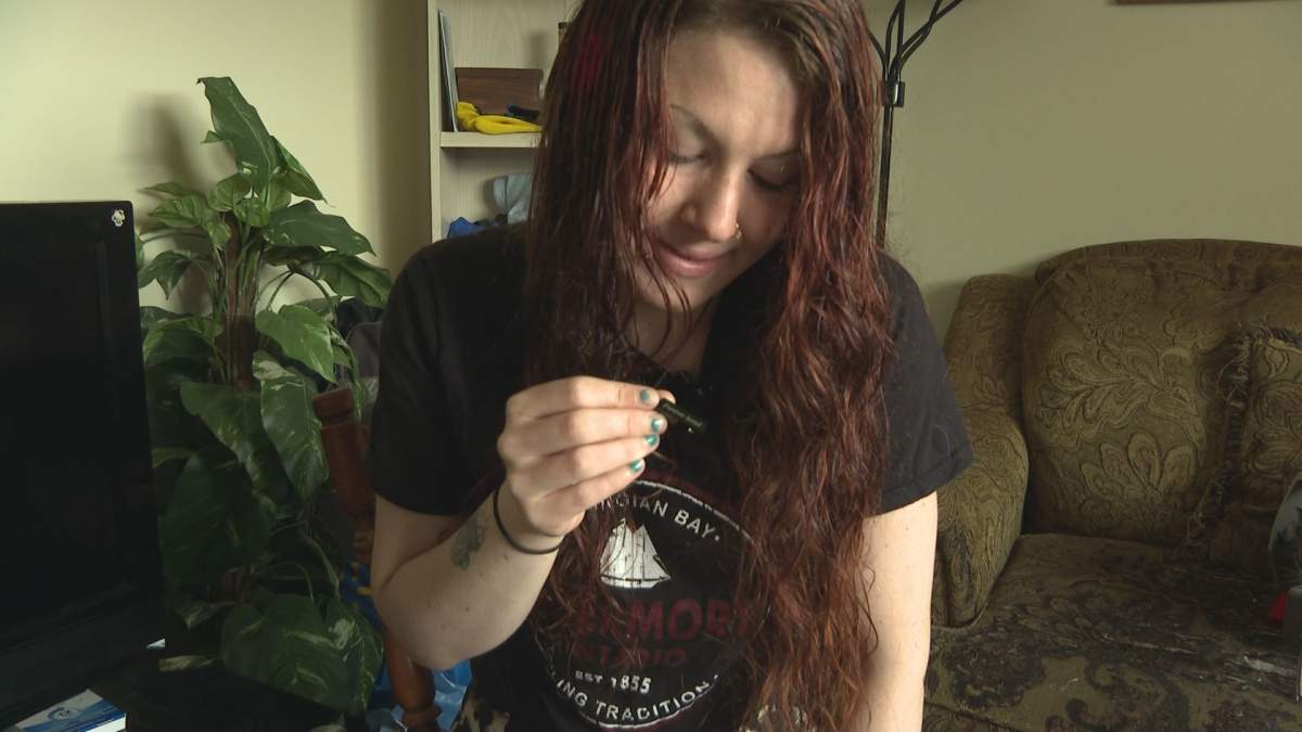 Adrienne Trenholm, who's been close friends with Desmond for more than a decade, holds up her necklace.