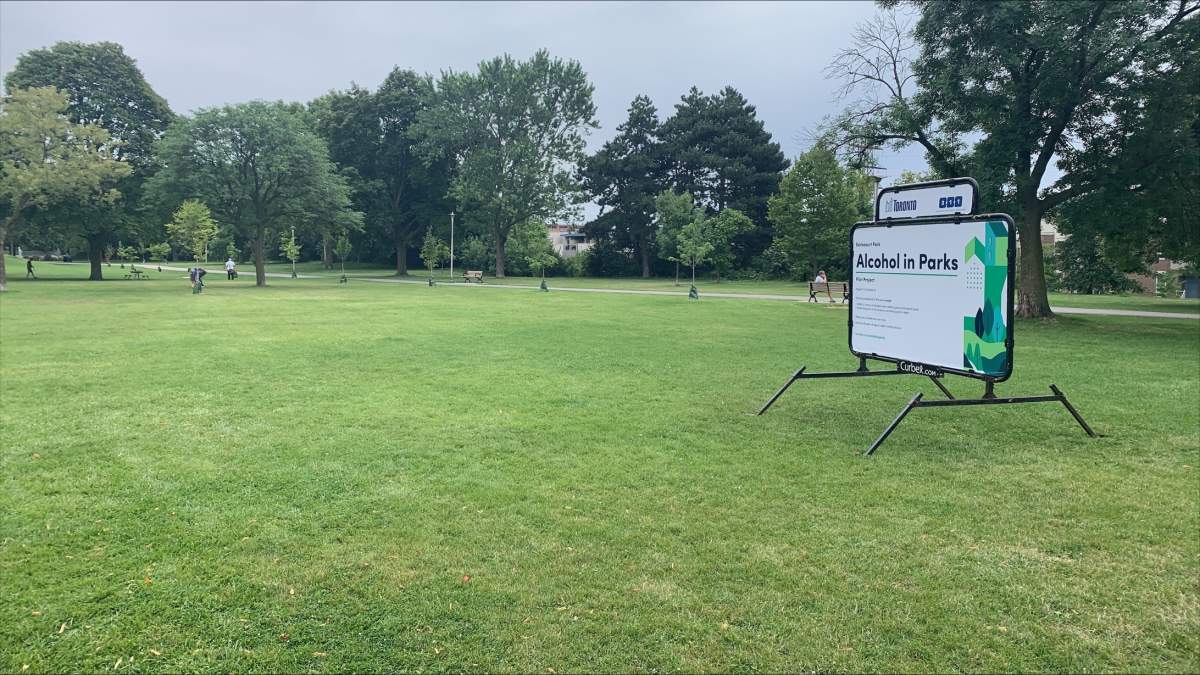 Signs for consuming alcohol in public parks in Toronto on Aug. 2, 2023