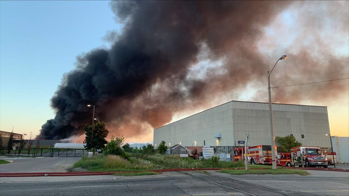 Heavy thick smoke comes from industrial site in north Etobicoke after fire breaks out on Aug. 11, 2023.
