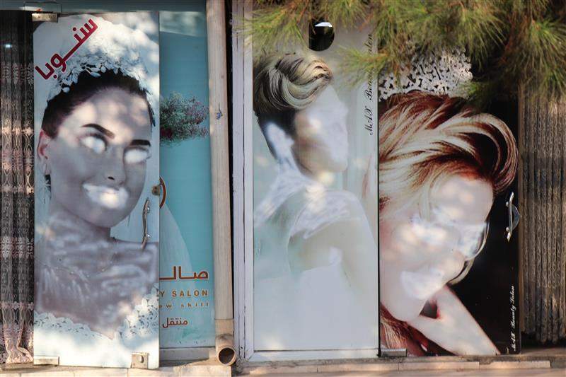 Images of women on a beauty salon in the Afghan capital Kabul are seen painted over in a photo taken September 2021.