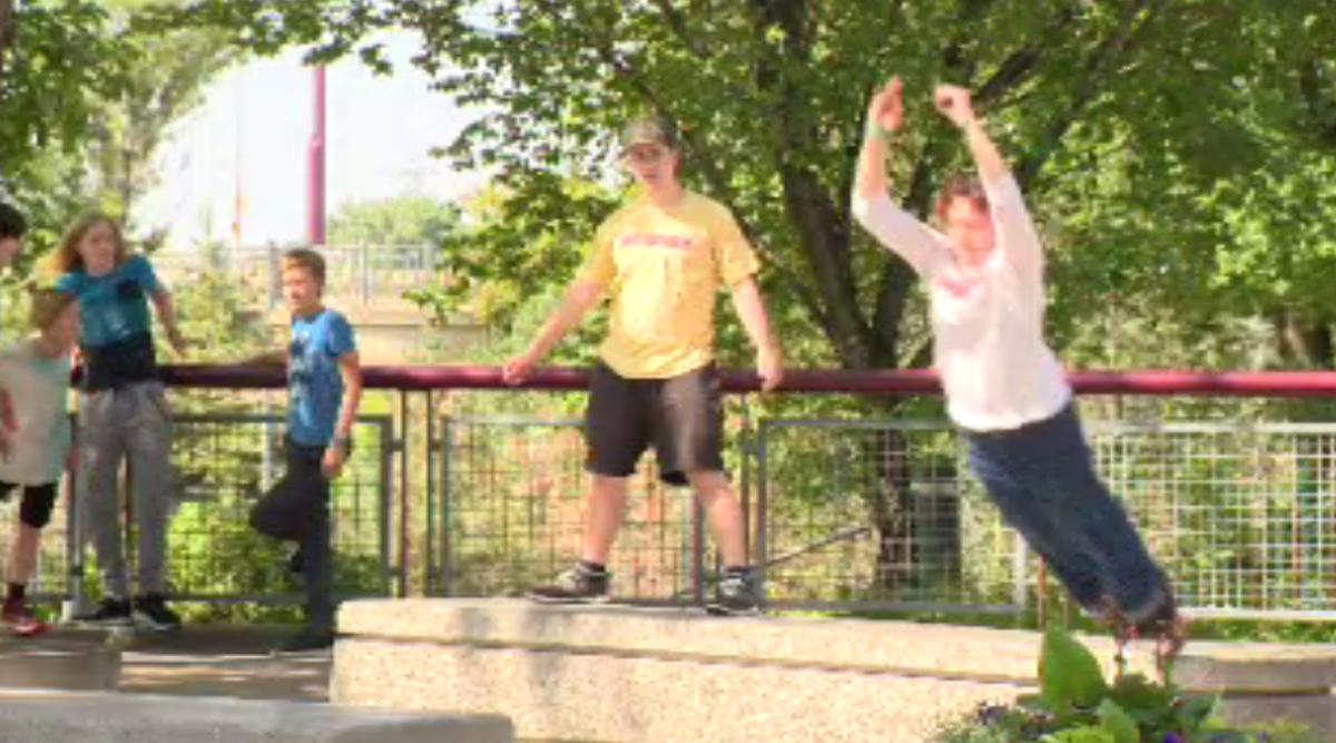 Parkour athletes leap from one bench to another