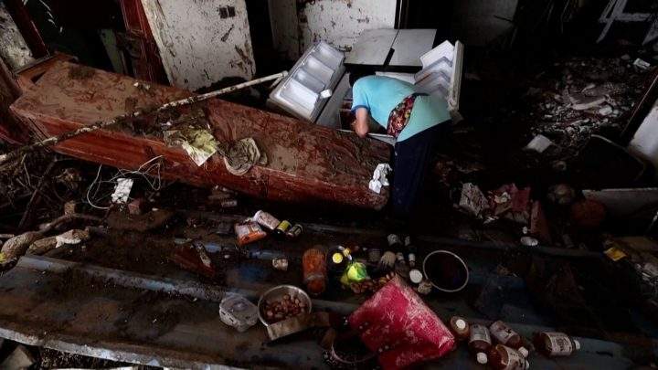 Gao sifts through his fridge on Aug. 4, 2023, for any edible food that remains after flooding swept into his home in the Mentougou district of western Beijing.