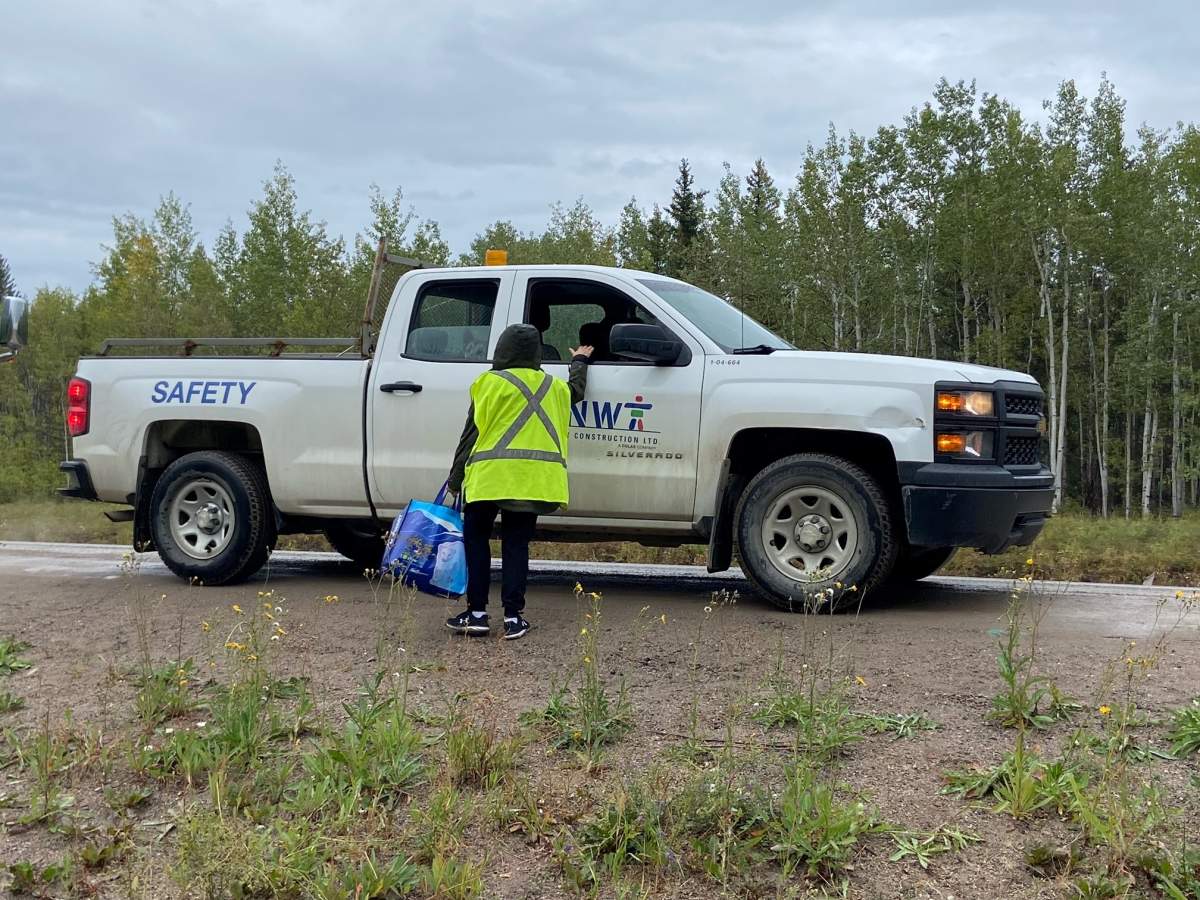 A volunteer standing at a safety truck after giving out supplies to people evacuating the Northwest Territories.