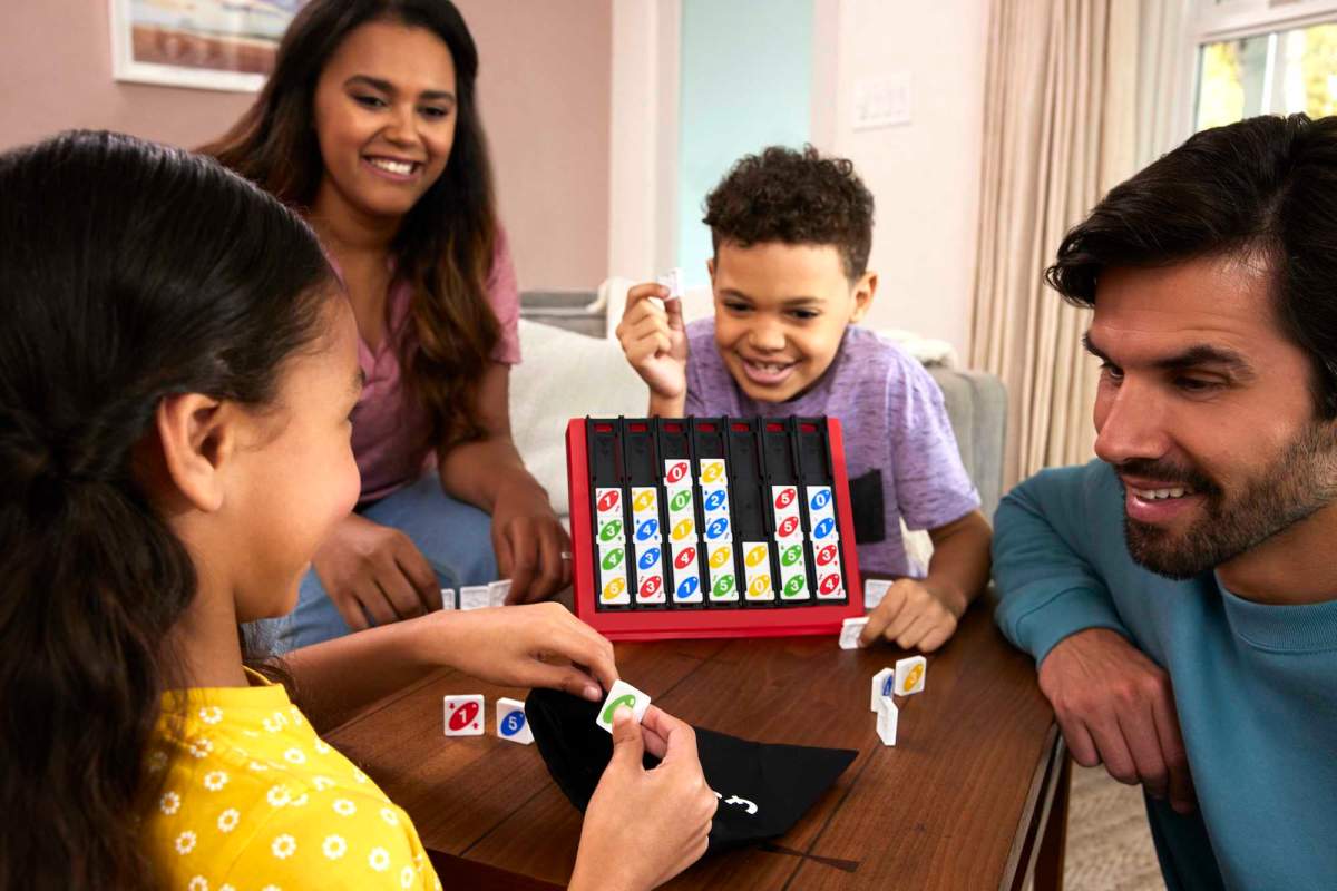 Family playing UNO Quatro, a new version of the UNO card game.