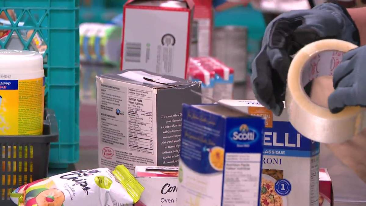 Volunteers prepare donations at Edmonton's Food Bank, Aug. 4, 2023.