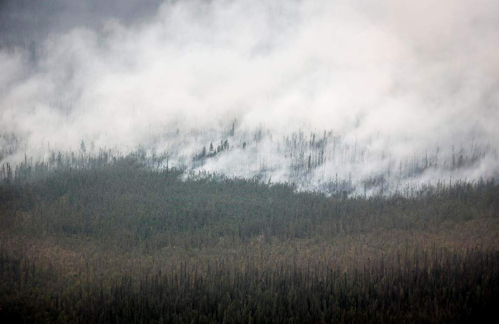 A wildfire burns south of Enterprise, N.W.T., Thursday, Aug. 17, 2023. THE CANADIAN PRESS/Jeff McIntosh.