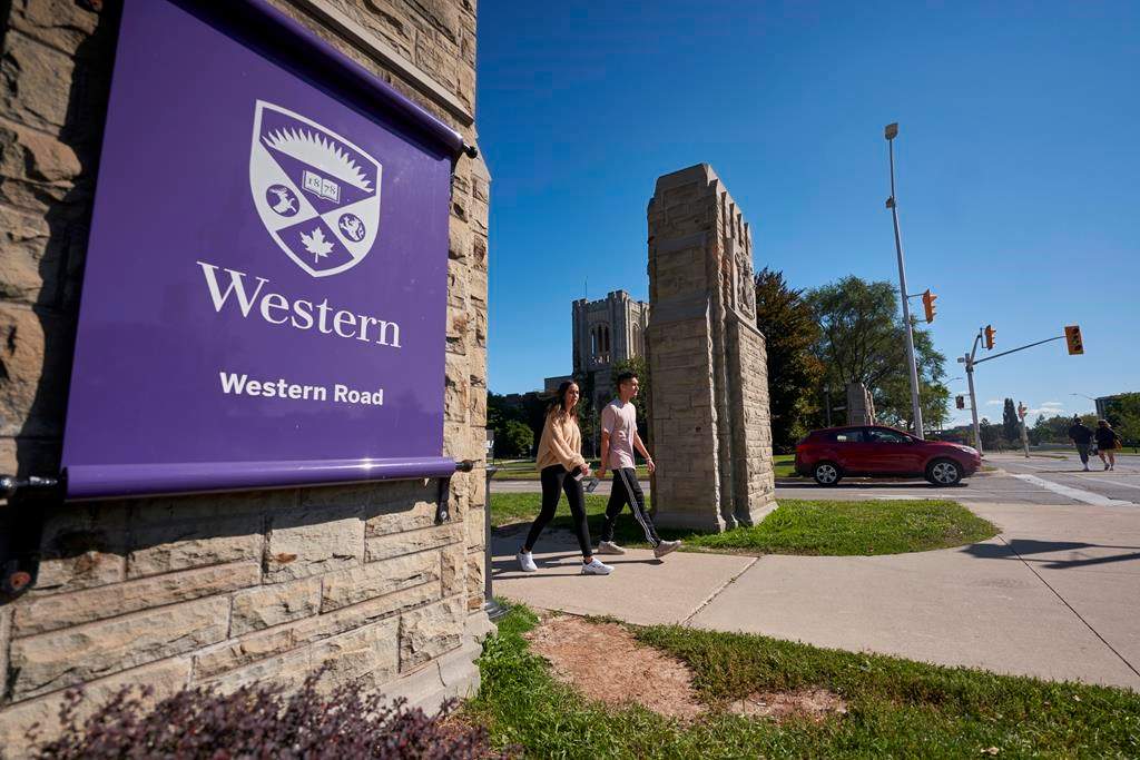 Students walk across campus at Western University in London, Ont., Saturday, Sept. 19, 2020. THE CANADIAN PRESS/Geoff Robins.