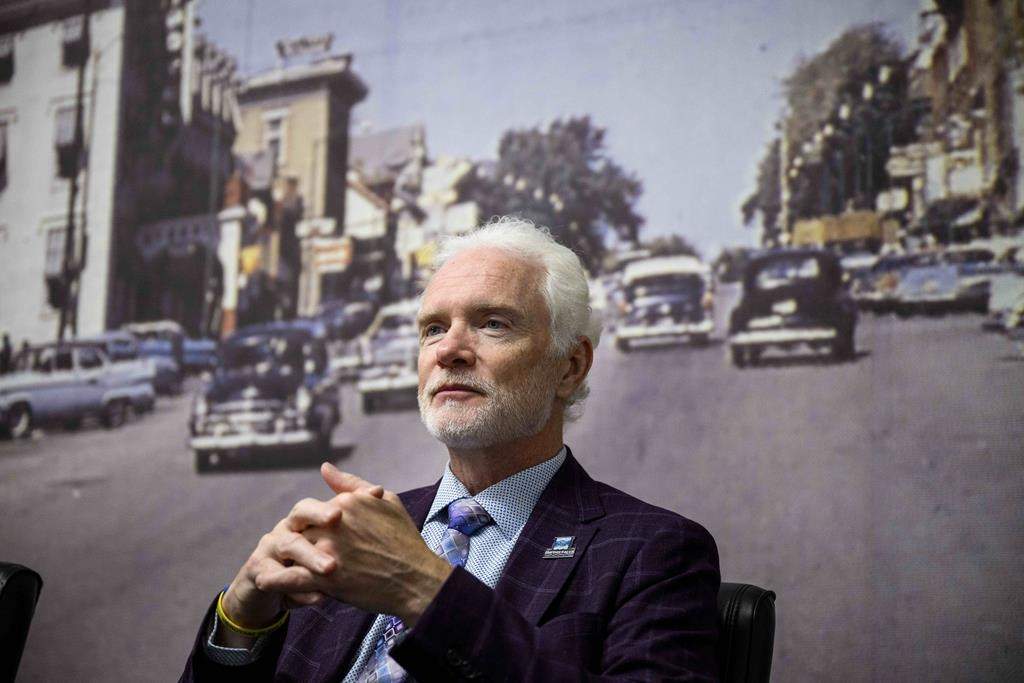 An archive image of Smiths Falls is seen on the wallpaper behind Mayor Shawn Pankow as he participates in an interview at the Town Hall in Smiths Falls, Ont., on Wednesday, Aug. 30, 2023. THE CANADIAN PRESS/Justin Tang.