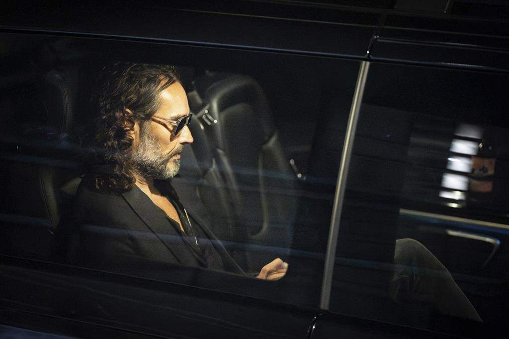 FILE - Russell Brand leaves the Troubabour Wembley Park theater in northwest London after performing a comedy set on Saturday, Sept. 16, 2023.
