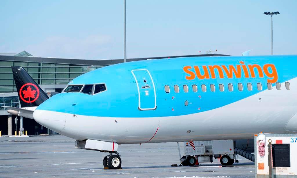 A Sunwing aircraft is parked at Montreal Trudeau airport in Montreal on Wednesday, March 2, 2022. WestJet says it aims to wind down Sunwing Airlines and integrate the low-cost carrier into its mainline business by October of next year.