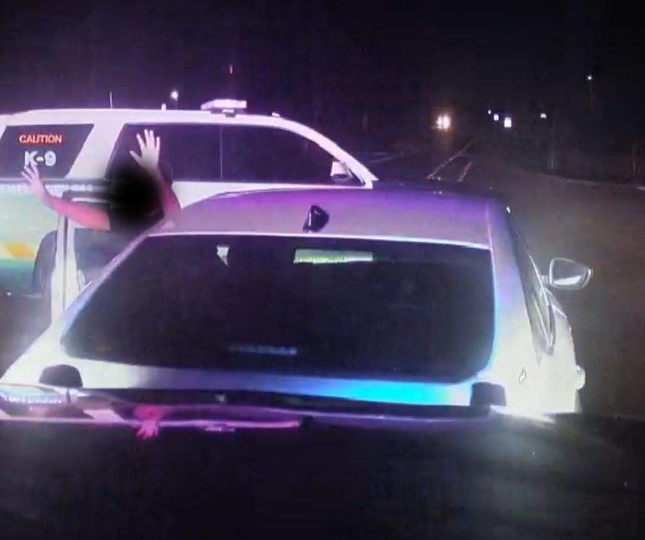Photo of a 10-year-old boy exiting a car after he and his 11-year-old sister were caught by police driving their mom's vehicle.