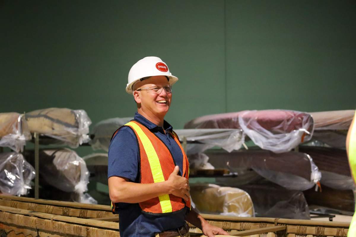 Canadian Canoe Museum curator Jeremy Ward in the new exhibition hall with some of the canoes that have moved from the former museum site.
