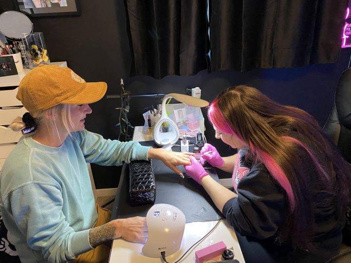 Sylvia Terelak creates a hand-painted set of nails for client Danika White.