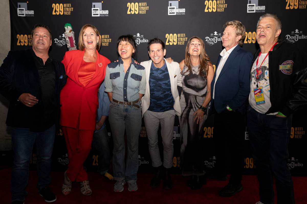 People posing for a photo at a documentary premiere.
