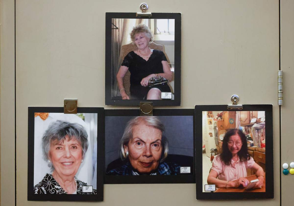 Photos of victims Mary Brooks, Martha Williams, Mary Bartel and Lu Thi Harris hang on the door during the third court trial of Billy Chemirmir at Frank Crowley Courts Building in Dallas on Thursday, Oct. 6, 2022.