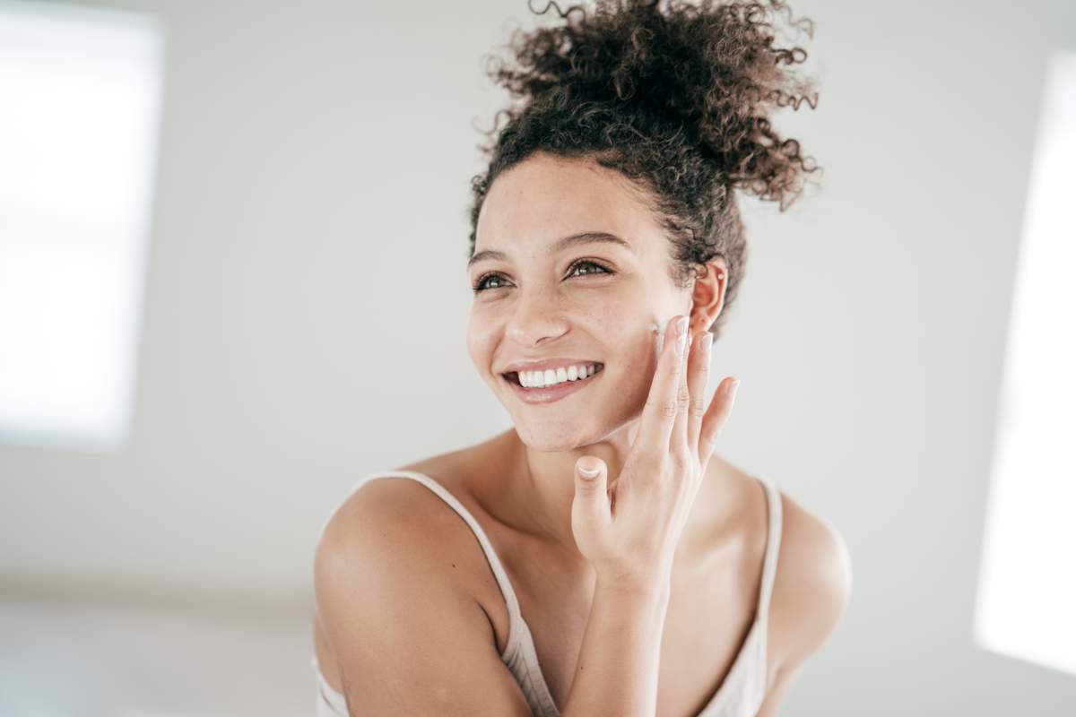 Woman applies face cream