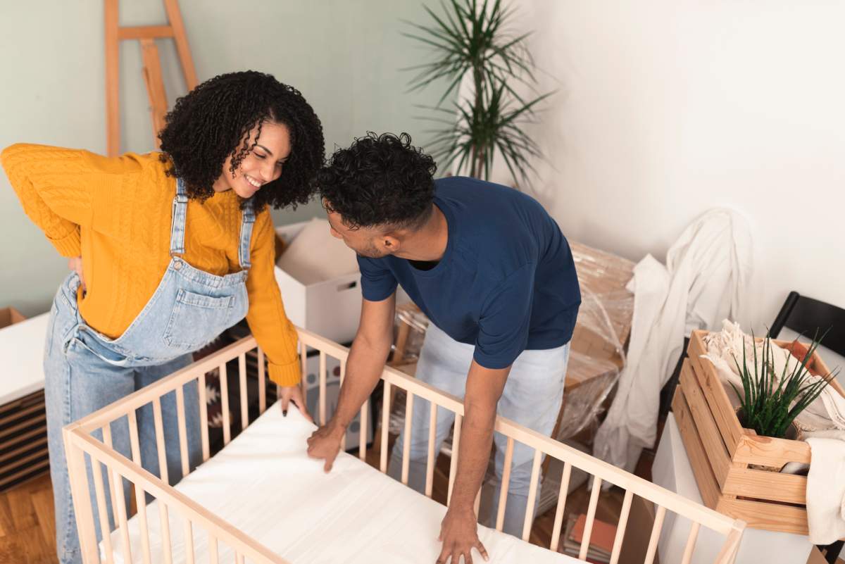 Couple expecting a baby start building the crib