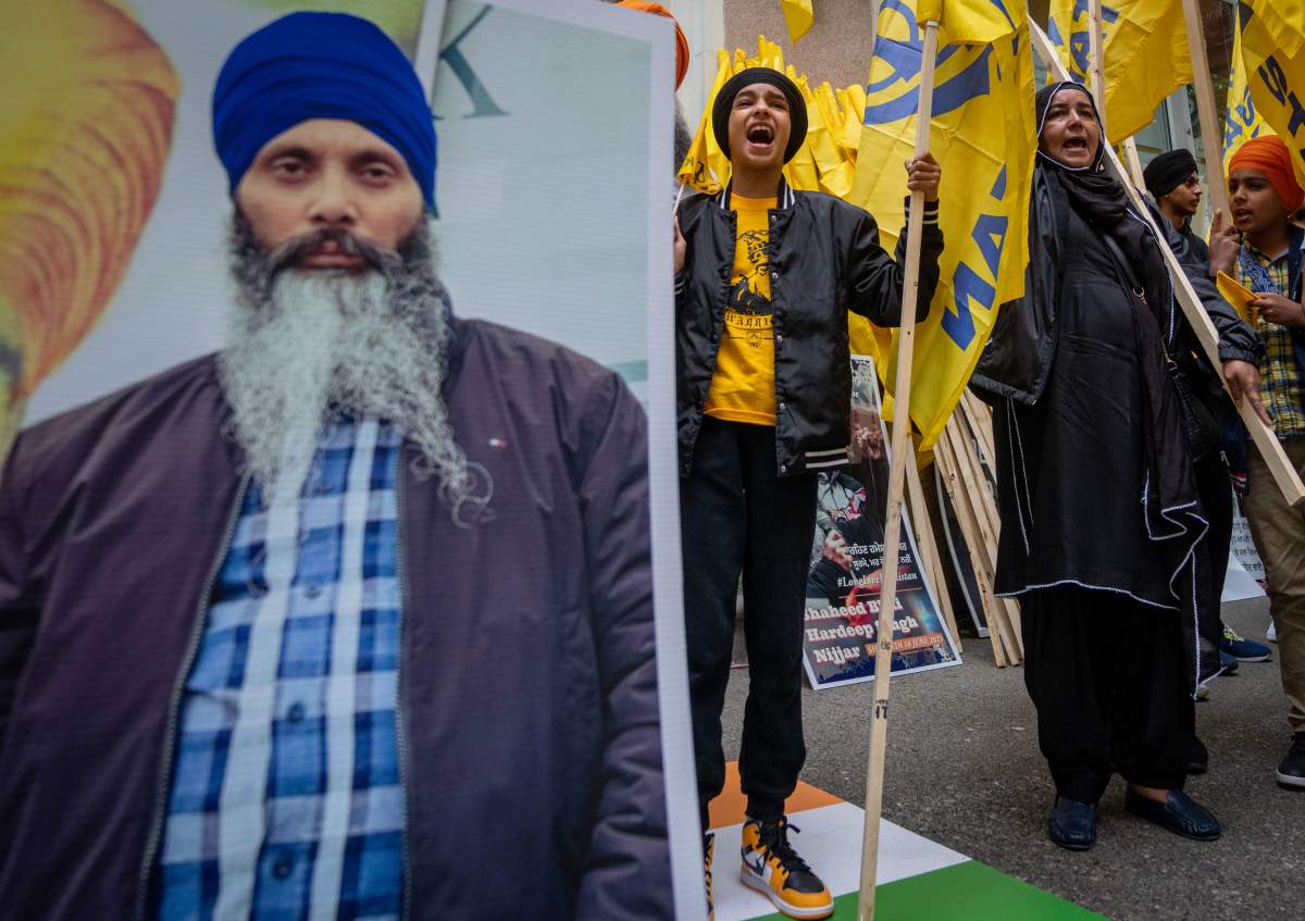 Protesters chant outside of the Consulate General of India office during a protest for the recent shooting of Hardeep Singh Nijjar in Vancouver on Saturday