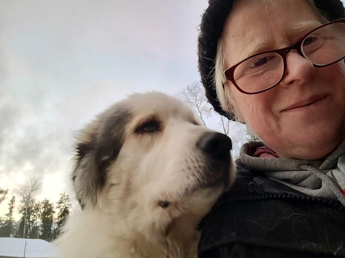 A woman poses for a selfie with her dog