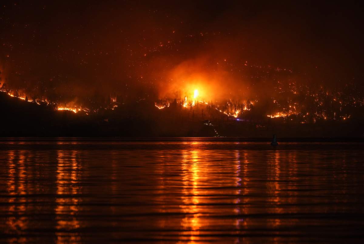 The McDougall Creek wildfire burns on the mountainside