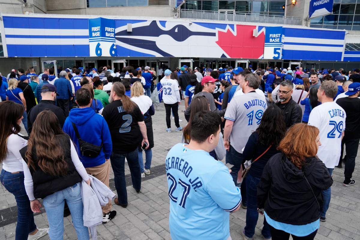 Fans line up to enter the Rogers Centre for the Toronto Blue Jays home opener against the Detroit Tigers in MLB American League baseball action in Toronto on Tuesday, April 11, 2023.