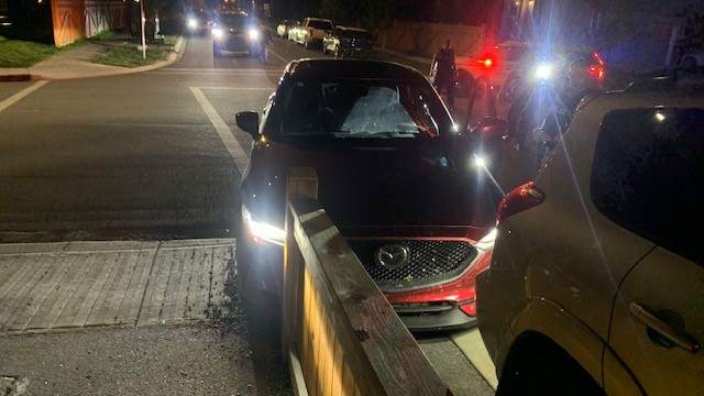 A damaged SUV following a stolen vehicle investigation in Cochrane that ended with two men charged and illicit drugs recovered from along the side of the road.