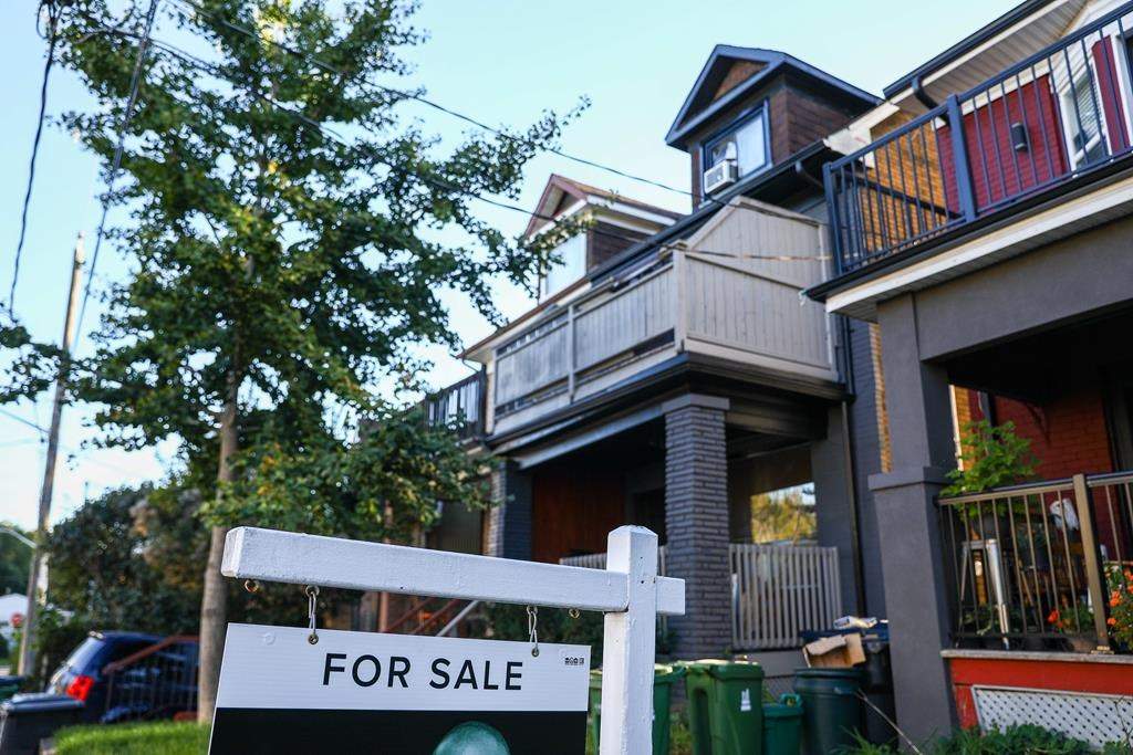 A for sale is sign is displayed in front of a house in the Riverdale area of Toronto on September 29, 2021. THE CANADIAN PRESS/Evan Buhler.
