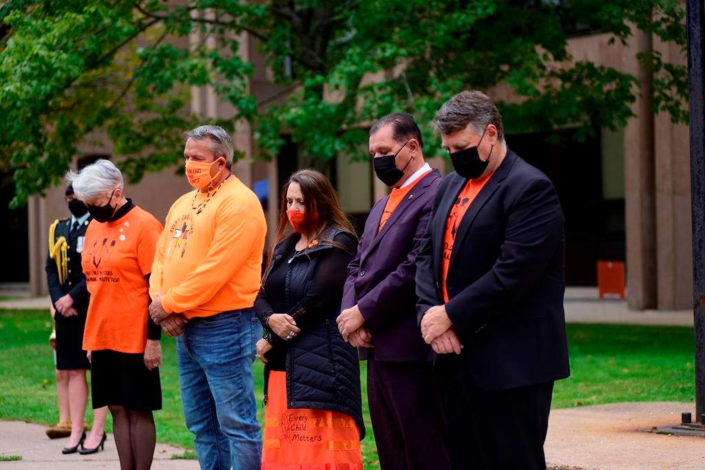 P.E.I. Lt.-Gov. Antoinette Perry, Roderick “Junior” Gould, chief of Abegweit First Nation, Darlene Bernard, chief of Lennox Island First Nation, Sen. Brian Francis and P.E.I. Premier Dennis King, observe two minutes of silence in honour of the residential school victims during a National Day for Truth and Reconciliation service in Charlottetown, Thursday, Sept. 30, 2021. A First Nation chief and the mayor of a small P.E.I. community are calling for a village councillor’s resignation over a hateful anti-Indigenous sign posted on his property. THE CANADIAN PRESS/Brian McInnis.