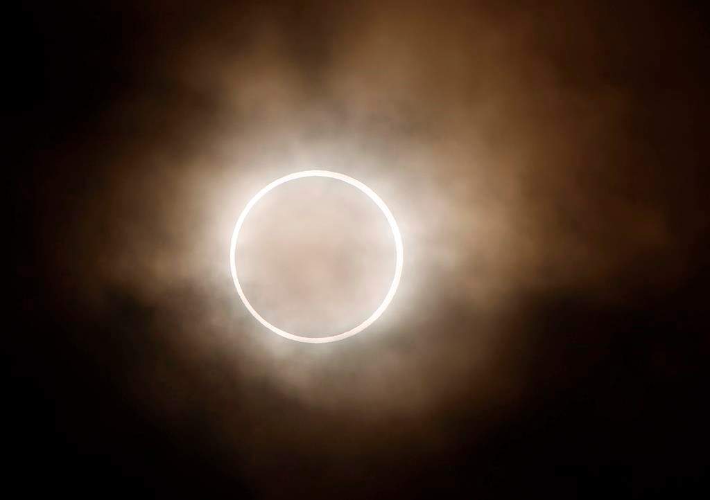 FILE - An annular eclipse is viewed from a waterfront park in Yokohama, Japan, near Tokyo, Monday, May 21, 2012. On Saturday, Oct. 14, 2023, an annular solar eclipse -- better known as a ring of fire -- will briefly dim the skies over parts of the western U.S. and Central and South America. Proper protection is needed throughout the eclipse, from the initial partial phase to the ring of fire to the final partial phase. (AP Photo/Shuji Kajiyama, File).